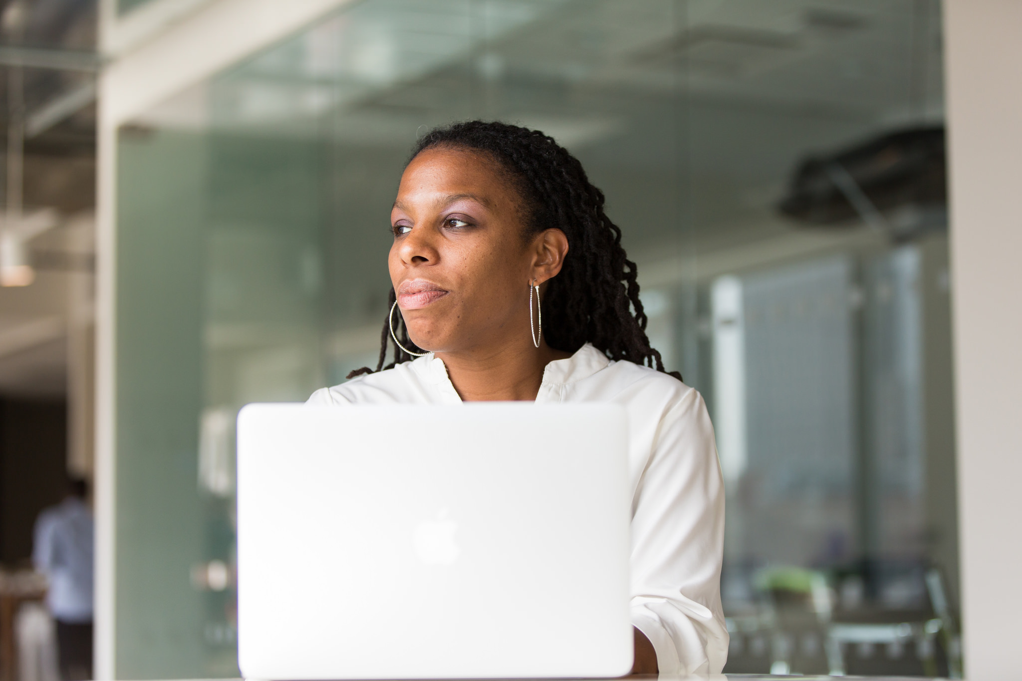 Stock Photo of a Woman of Color Sitting behind a Laptop